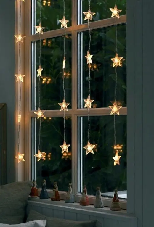 The cool thing about hanging star-shaped Christmas lights on your windows is that they provide some moody light to your rooms and make your house looks gorgeous outside.