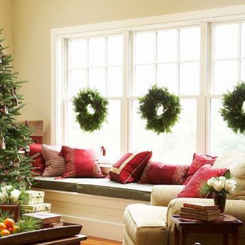 Classic Christmas wreaths looks better in multiples, especially if your window is actually a combination of several windows.