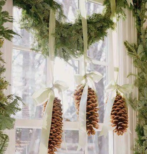 Pinecones are great for different kinds of Christmas decorations and looks especially good on hung from an evergreen swag framing a window.