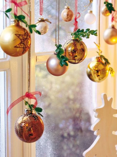 Nothing could be simpler than to hang ornaments on a curtain's rod. Just make sure to use the same ornaments you're using for the Christmas tree. Your decor would be much more sophisticated this way.