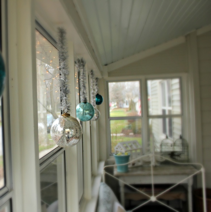 Transparent glass ornaments hung in windows will catch light and send reflections throughout the room.