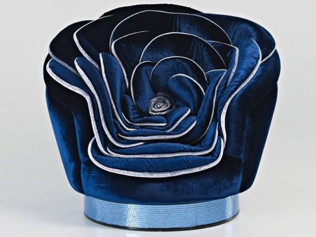 A navy velvet rose shaped chair with silver edges is a cool and bold idea for a refined and moody space, it will bring a romantic touch