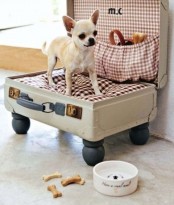 a vintage suitcase turned into a comfy and cozy dog bed with plaid fabric and a cushion won’t spoil that vintage style that you have