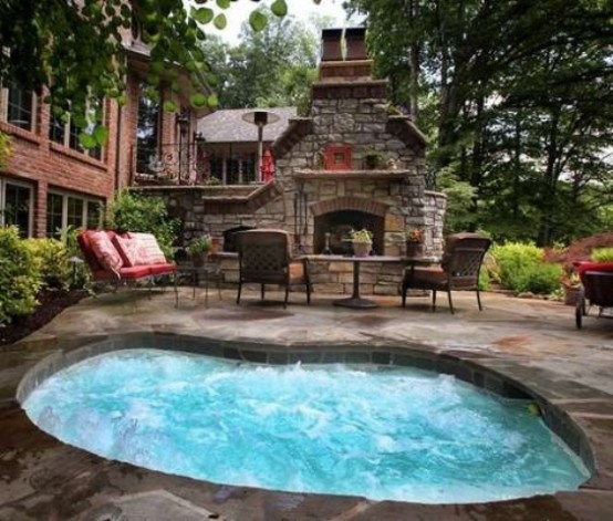 A patio with an in-ground hot tub jacuzzi and a fireplace could make every summer evening special.