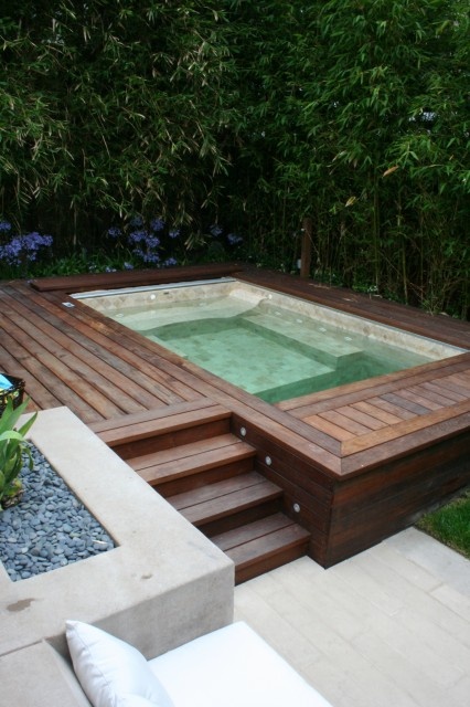 Wood decking is perfect contemporary surrounding for a hot tub because it's looks quite sophisticated and comfy to use.