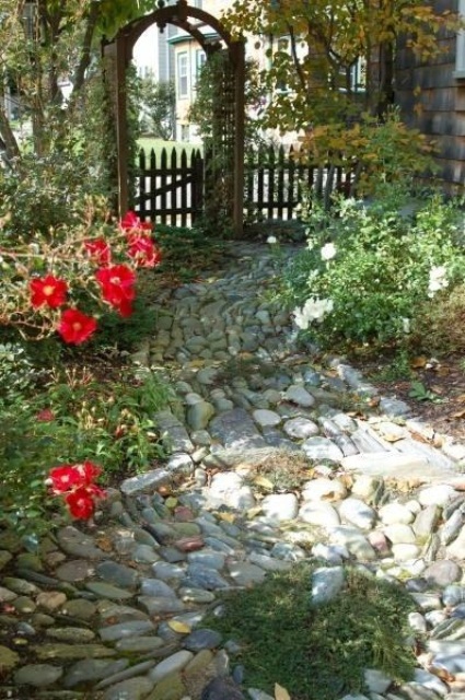 A stone garden path of muted color stones forming a chaotical pattern will fit a secret garden or a fairy inspired one
