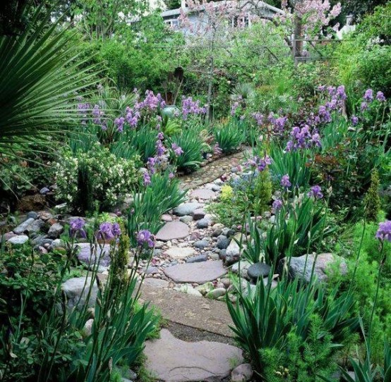 a stone and pebble garden path like this one looks very natural and casual, and will fit most of gardens