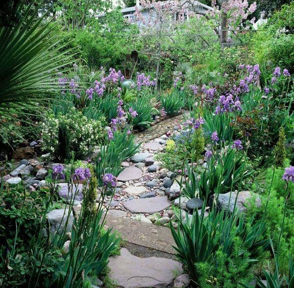 A stone and pebble garden path like this one looks very natural and casual, and will fit most of gardens