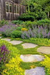 a rough stone garden path with a large space in between each piece and moss growing for a natural feel