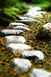 a rough and small stone garden path with sand around is a cool idea with a natural feel though walking on it isn’t very comfortable