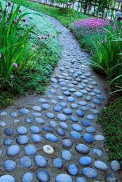 a sand and stone pathway in your garden contrasts the bright blooms, and though it’s harder to walk on it, it looks pretty