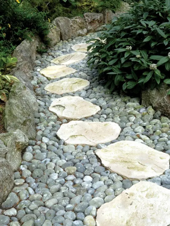 a pebble and rough stone garden path looks natural yet manicured enough and catchy