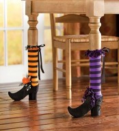 table legs dressed up as witches’ legs are a fun and cool idea for a Halloween space, and you may use them not only for a witch-inspired party