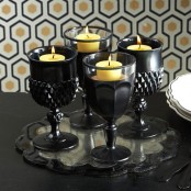 large black goblets used as candleholders are a smart idea for Halloween, they are perfect for decor