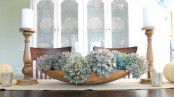 a dough bowl with blue hydrangeas is a stylish famrhouse centerpiece that can be DIYed in a minute