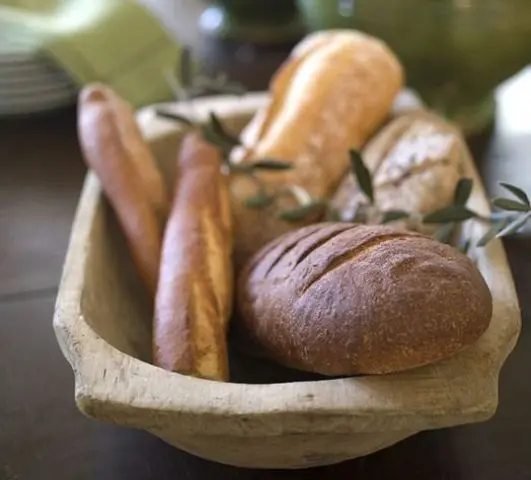 A dough bowl with fresh bread is an edible centerpiece idea  what can be more natural than storing bread in a dough bowl