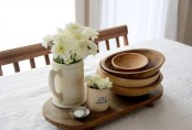 small wooden dough bowls and some blooms can make up a stylish rustic centerpiece