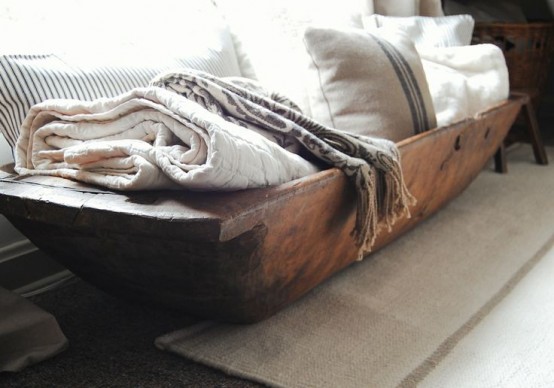 storing towels and pillows in a dough bowl is a cool and simple idea with a rustic feel