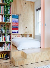 a plywood platform and a matching headboard wall with a niche is a contemporary solution