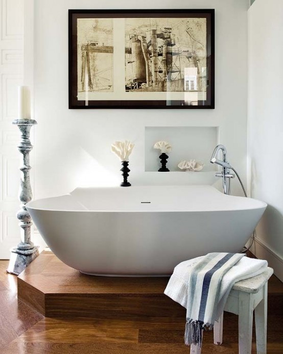 a raised platform highlights the bathtub in the bathroom making this space an oasis