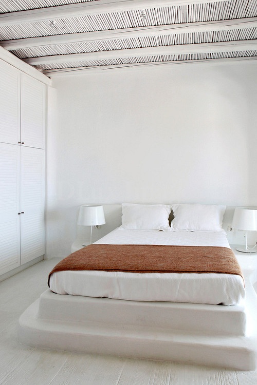 a stepped platform instead of a usual bed is a cool solution for an island bedroom