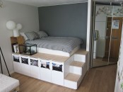 a space-saving platform with a sleeping space, drawers for storage and even photos attached