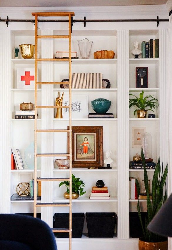 A rolling ladder is what you need if your bookcases are tall. Besides it spice things up.