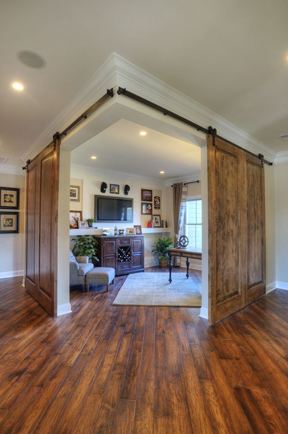 rustic sliding doors add a cozy feel to the space and let open it to the rest of the house anytime