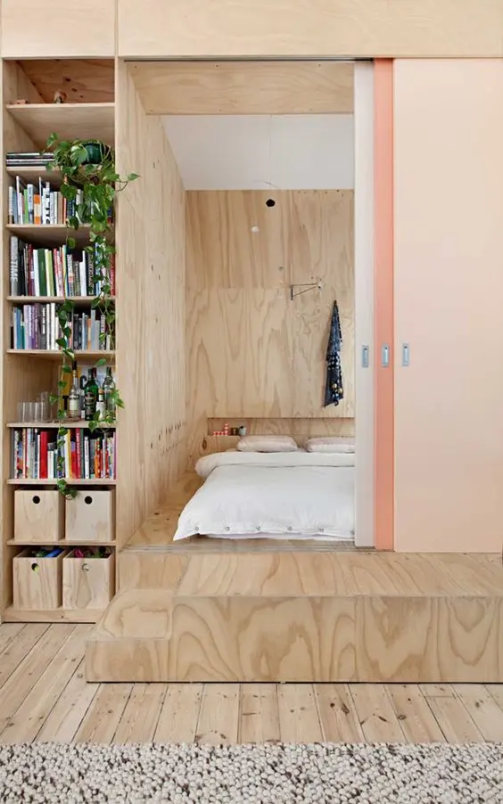 sliding doors hide the bedroom on a platform without wasting much space