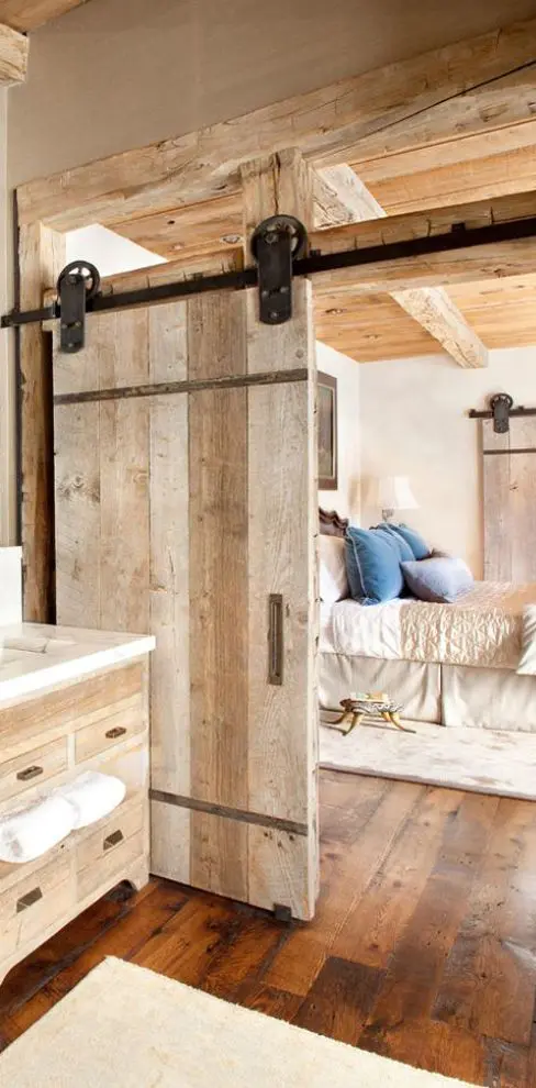 a rough wood sliding door for a rustic touch and cozy feel in the space