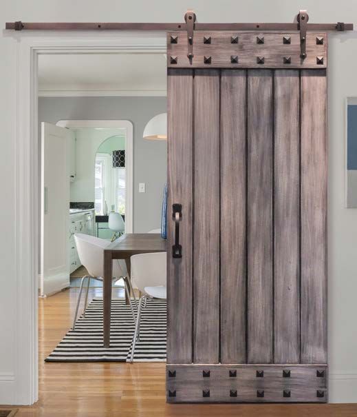 a rustic wooden sliding door with studs is a cool idea for a cozy yet rock touch