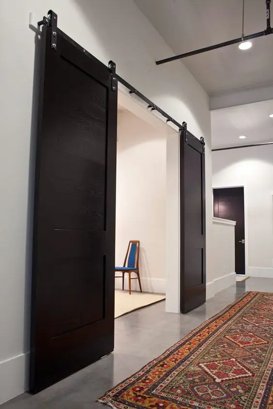 modern dark stained sliding doors contrast the interiors and make them look bolder