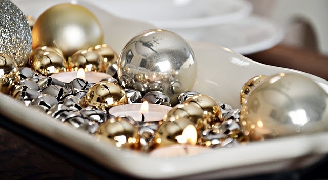 A white tray with silver and gold bells, tealights and silver and gold ornaments is a simple last minute centerpiece or just decoration to rock