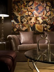 an elegant masculine living room with brown upholstered furniture, a patchwork artwork and elegant and refined table lamps