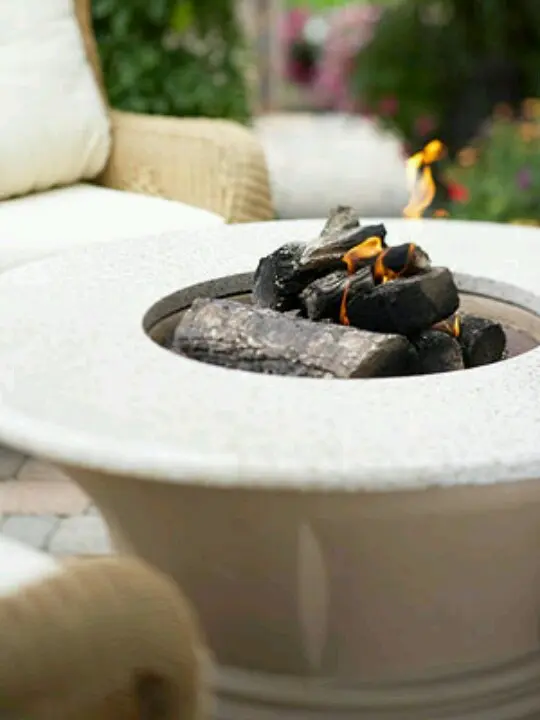 A classic neutral stone fire bowl with a countertop to place a glass of wine or s'mores here always works for a mid century modern outdoor space
