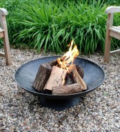a simple black forged metal bowl is a lovely idea for any backyard, it won’t break the bank and will give coziness to the space