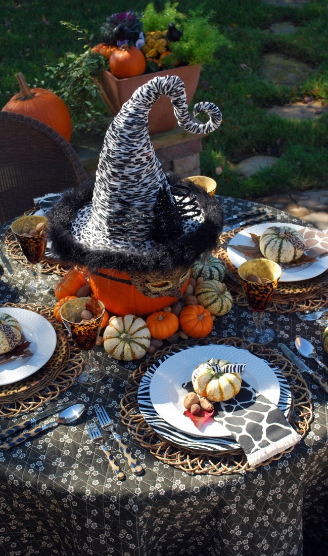 Make a cute centerpiece by dressing a pumpkin in a witch hat and eye mask and surround it with tiny gourds.