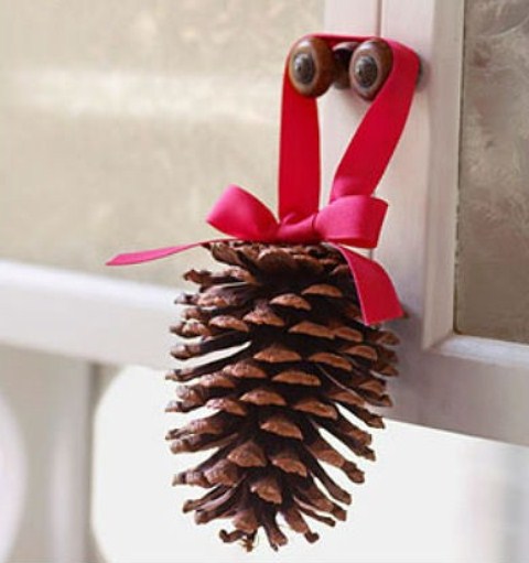 You can decorate kitchen cabinet doors with individual pinecones suspended on colorful ribbon pieces.