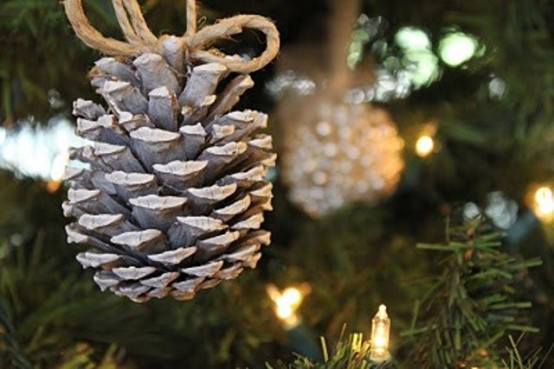 Suspend individual pinecones from an evergreen garland or from a Christmas tree using twine.