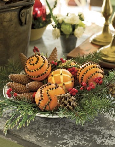 Pinecones, pomanders and holiday greens could easily become an awesome holiday arrangement for a table setting.