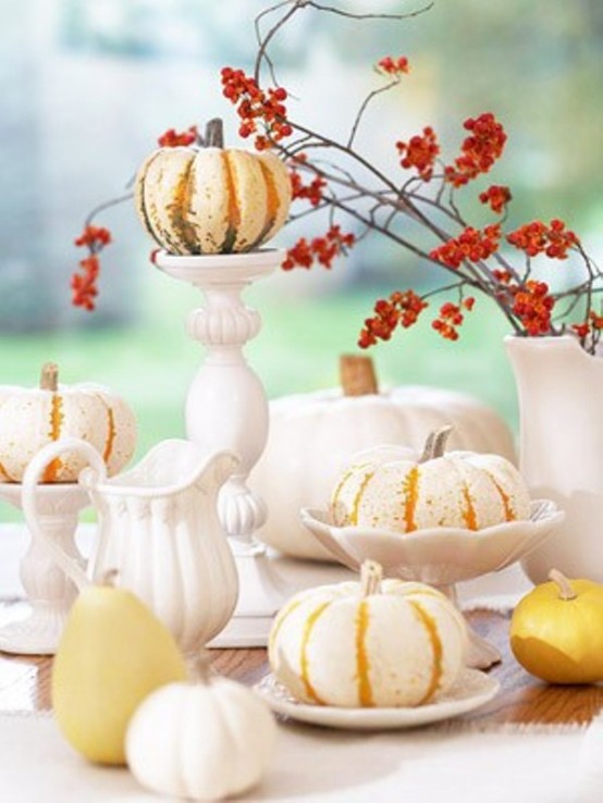 Painting pumpkins in white but leaving vertical orange stripes allows to create more original arrangements. You can use such arraignment as a centerpiece for Fall wedding.

Arranging pumpkin centerpieces is quite popular for Fall weddings.