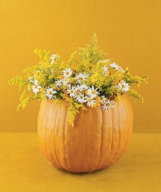Hide a vase filled with water inside a pumpkin for a long-lasting Fall display.