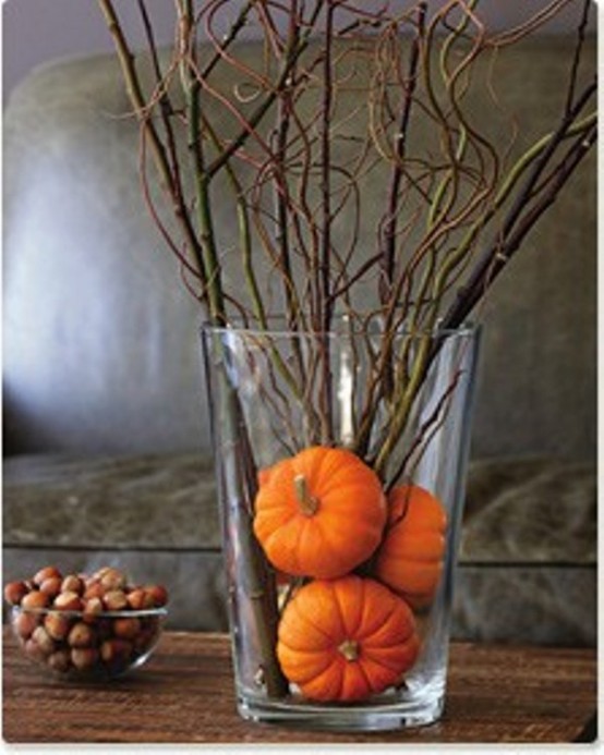 Simply put several very small pumpkins in a vase and add some twigs. Your got yourself a beautiful Autumn arrangement.