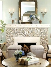 a fireplace clad with seashells is a bold and cool solution for a beach or seaside home