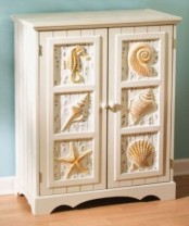 a white beadboard cabinet with seashells, seahorses and starfish looks chic and stylish and will accent any coastal space