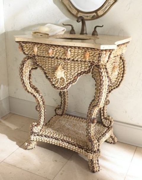 A sea inspired vanity clad with seashells and pebbles looks unusual, bold and catchy and a stone countertop adds interest