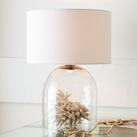 a unique table lamp with a coral in a cloche as a base and a plain lampshade for a seaside space