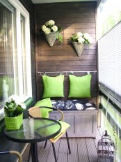 a green wicker pot, matching pillows attached to the wall and wicker planters hanging on it
