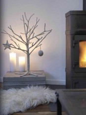 a white tree with a star and a bauble is a cool frozen idea for Christmas home decor