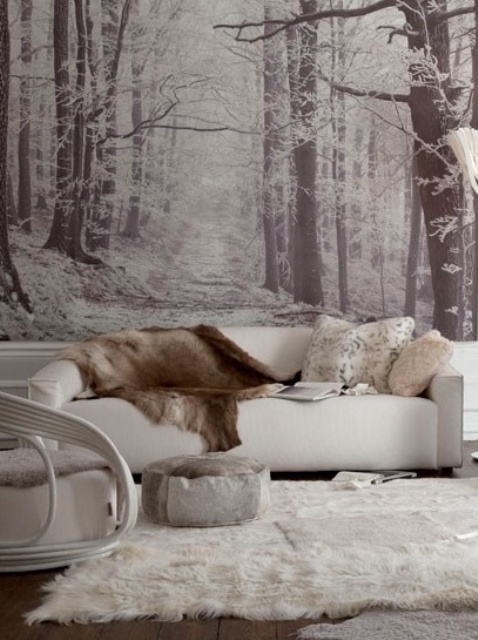 A black and white woodland wall mural matches the color scheme of the space and gives it more eye catchiness